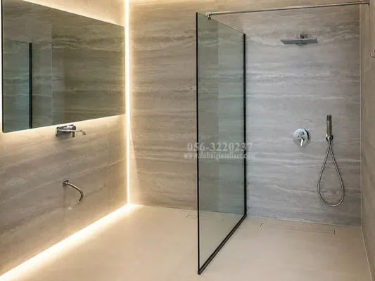 Frameless tempered glass shower screen with stainless steel top support bar.