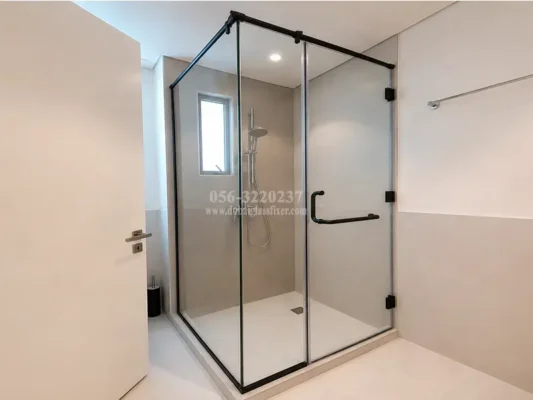 A stylish black corner shower enclosure that combines elegance with everyday functionality.