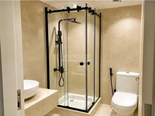 Black-framed double sliding shower enclosure with tempered safety glass for modern bathrooms.