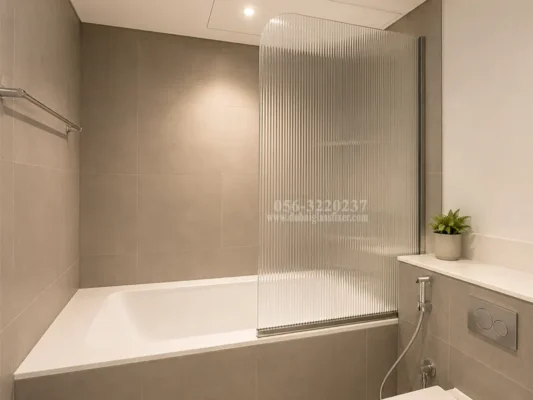 Fluted tempered glass bathtub screen installed in a contemporary bathroom.