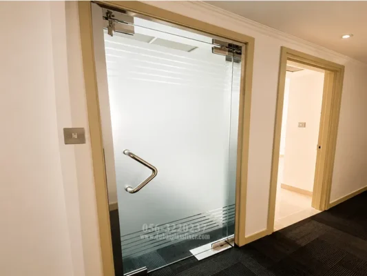 Frameless office glass door with frosted privacy film and tempered safety glass.