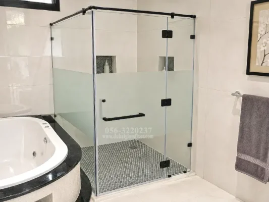 A stylish black-framed corner shower enclosure for a contemporary bathroom.