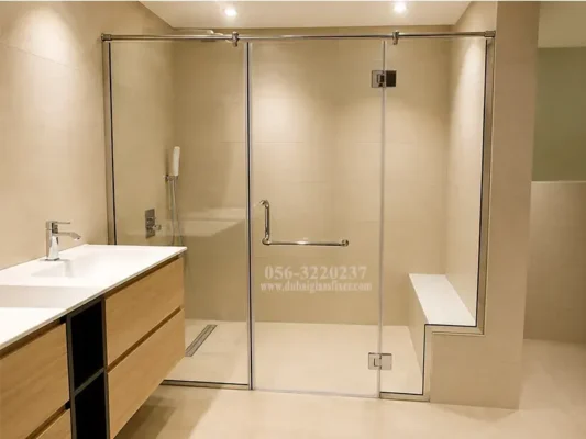 Custom frameless swing shower enclosure with cutout, made from tempered safety glass.